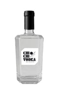Clear vodka bottle with black cap on a white background